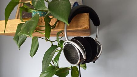 The Grell OAE2 headphone, hanging from a wooden shelf. 