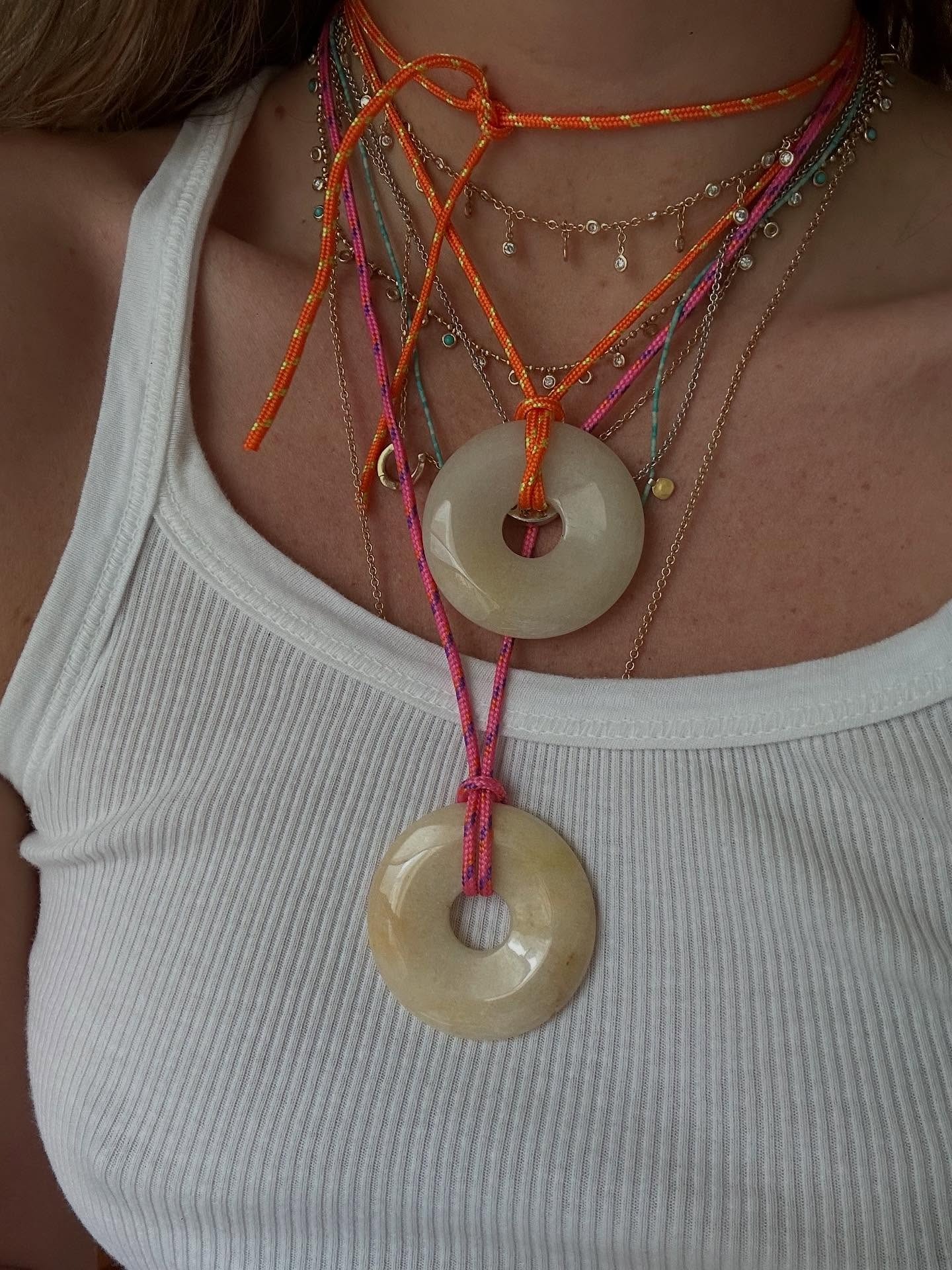 Woman wearing corded Pointe Milou necklaces