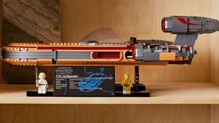 A side-on view of Lego Luke Skywalker's Landspeeder on a shelf
