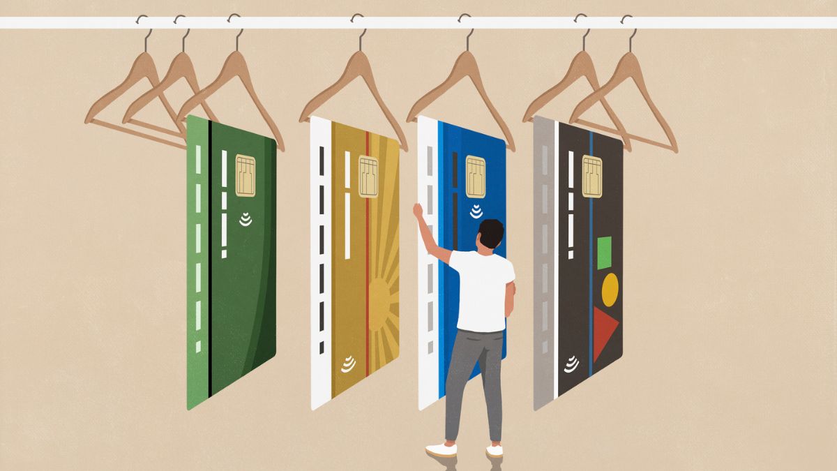 A man shopping, looking at different credit cards on display hangers