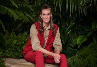 Jill Scott, I'm a Celebrity 2022 winner, in her camp clothes, sitting on a rock and smiling
