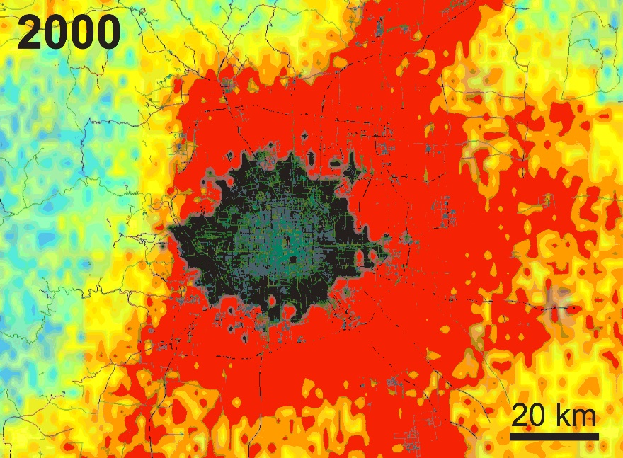 Gray and black indicate buildings, with the tallest and largest buildings in the city’s commercial core appearing lighter gray. Other colors show changes in areas not yet urbanized (for example, clearing land or cutting down trees), with the rate of change indicated by color. Blue-green indicates the least change, yellow-orange more change, and red the greatest change.