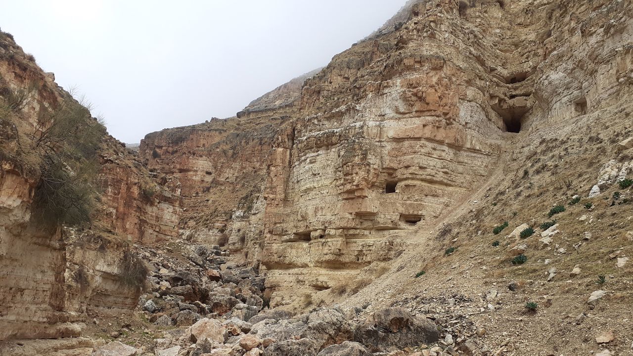A photo of the cave entrance at Wadi er-Rashash looking west. The Bar Kokhba coin was found in this cave. The cave had been looted in recent times.