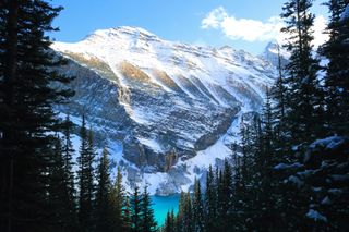 Snowcapped mountains behind Lake Louise in Banff National Park in Alberta, Canada