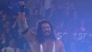 Kevin Nash raising his fist at WrestleMania XII.