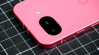 Google Pixel 9a held in the hand.