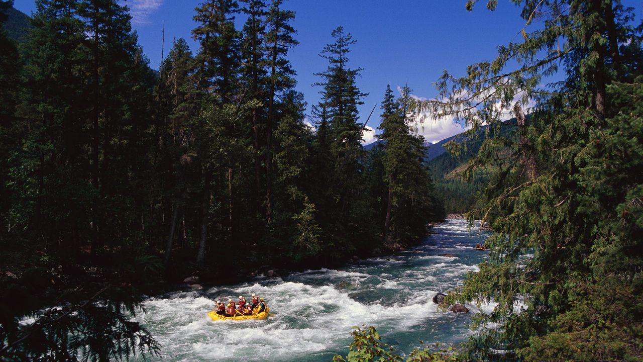 Rafters on a yellow inflatable boat paddle on the Nahatlatch River