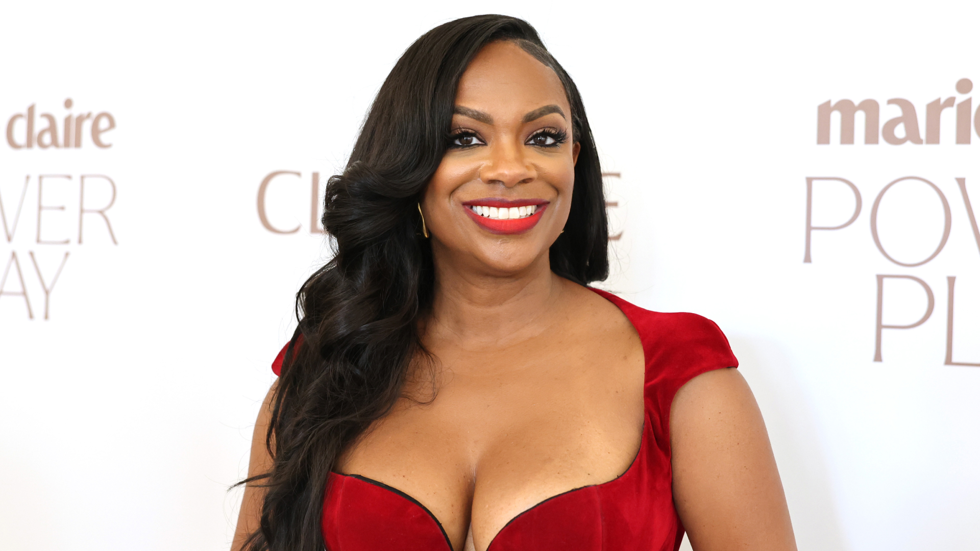 Kandi Burruss in front of a step and repeat for marie claire