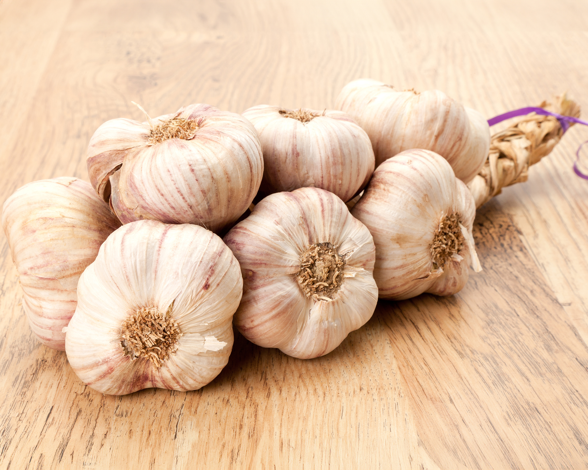 Braided garlic on wooden table
