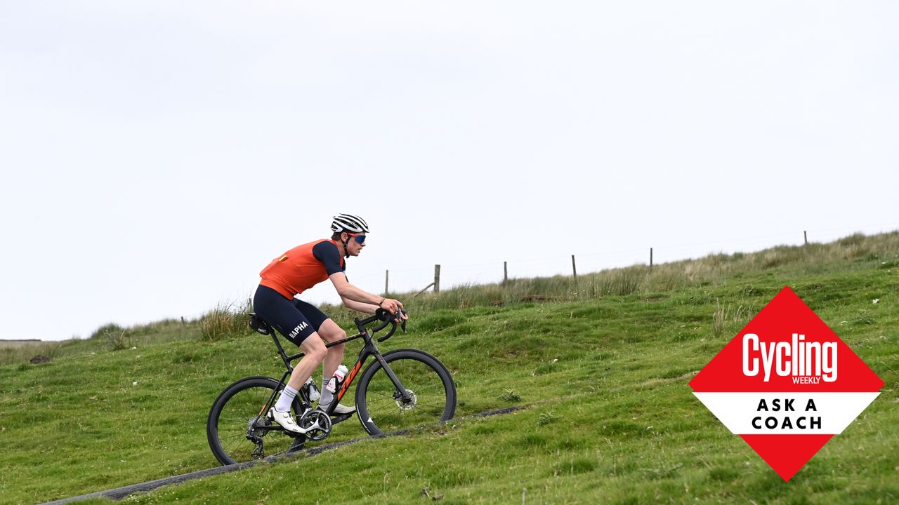 Male cyclist riding up a hill