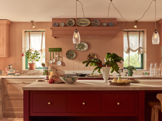 A kitchen with panelling on the walls, all painted orange