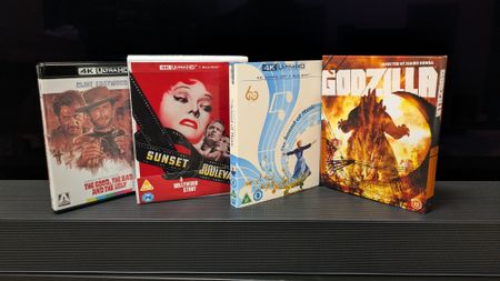 Photo of 4 4K Blu-rays, Sunset Boulevard, Godzilla, The Sound of Music and Seven Samurai, in front of a TV 