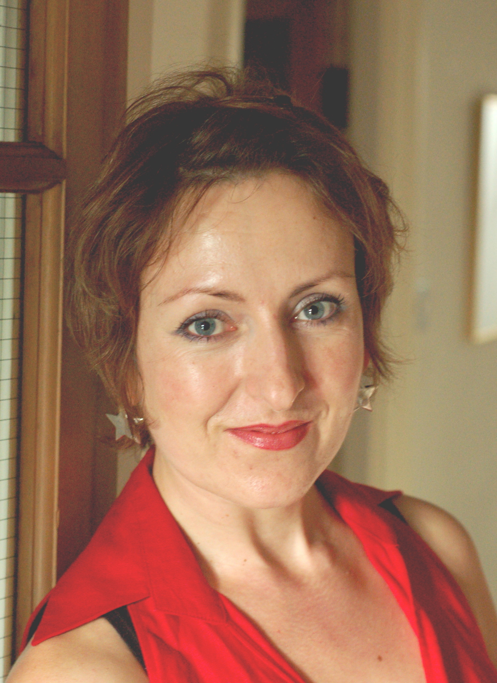 woman with short hair wearing red sleeveless shirt