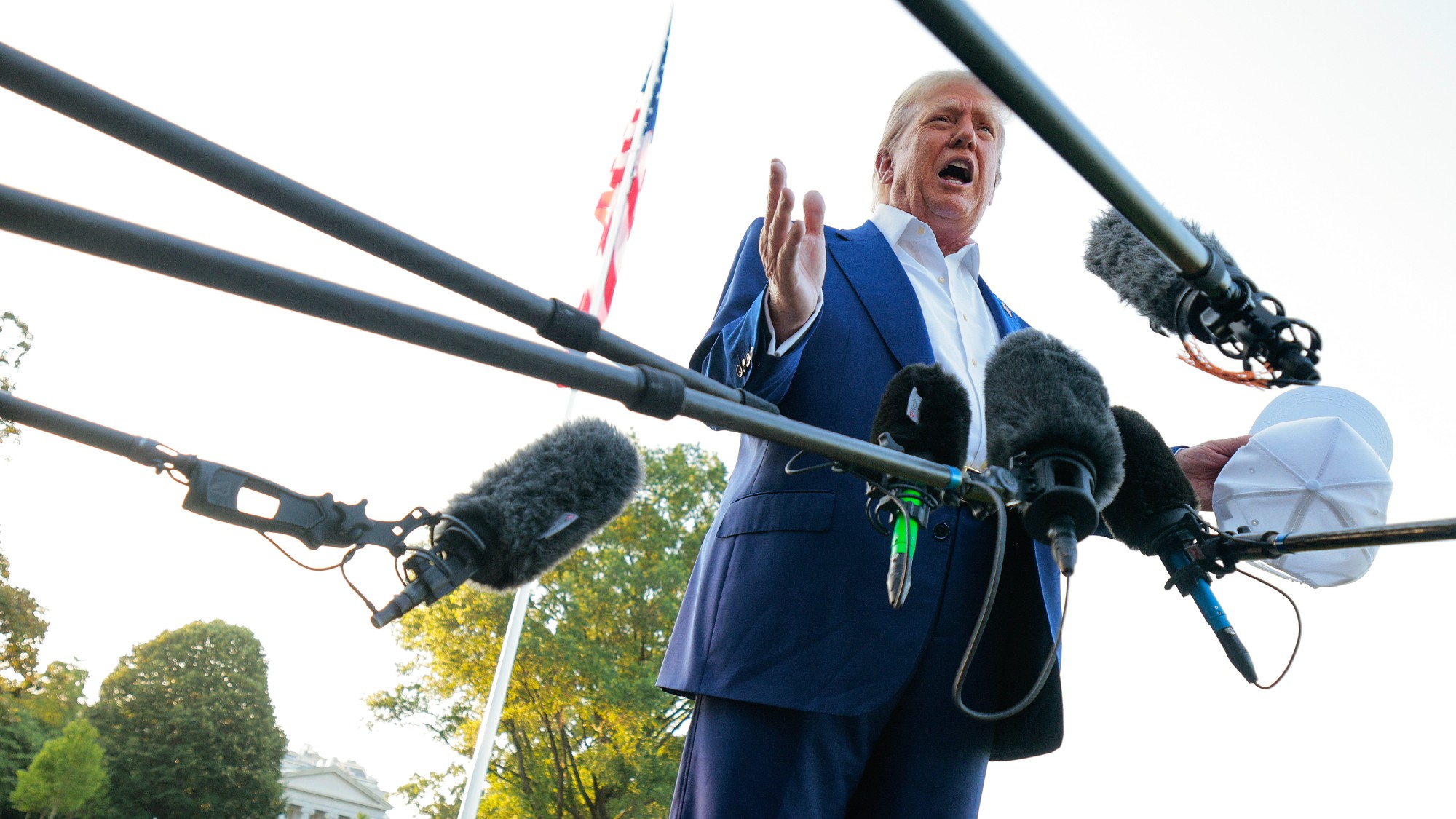 Donald Trump speaks to reporters outside the White House
