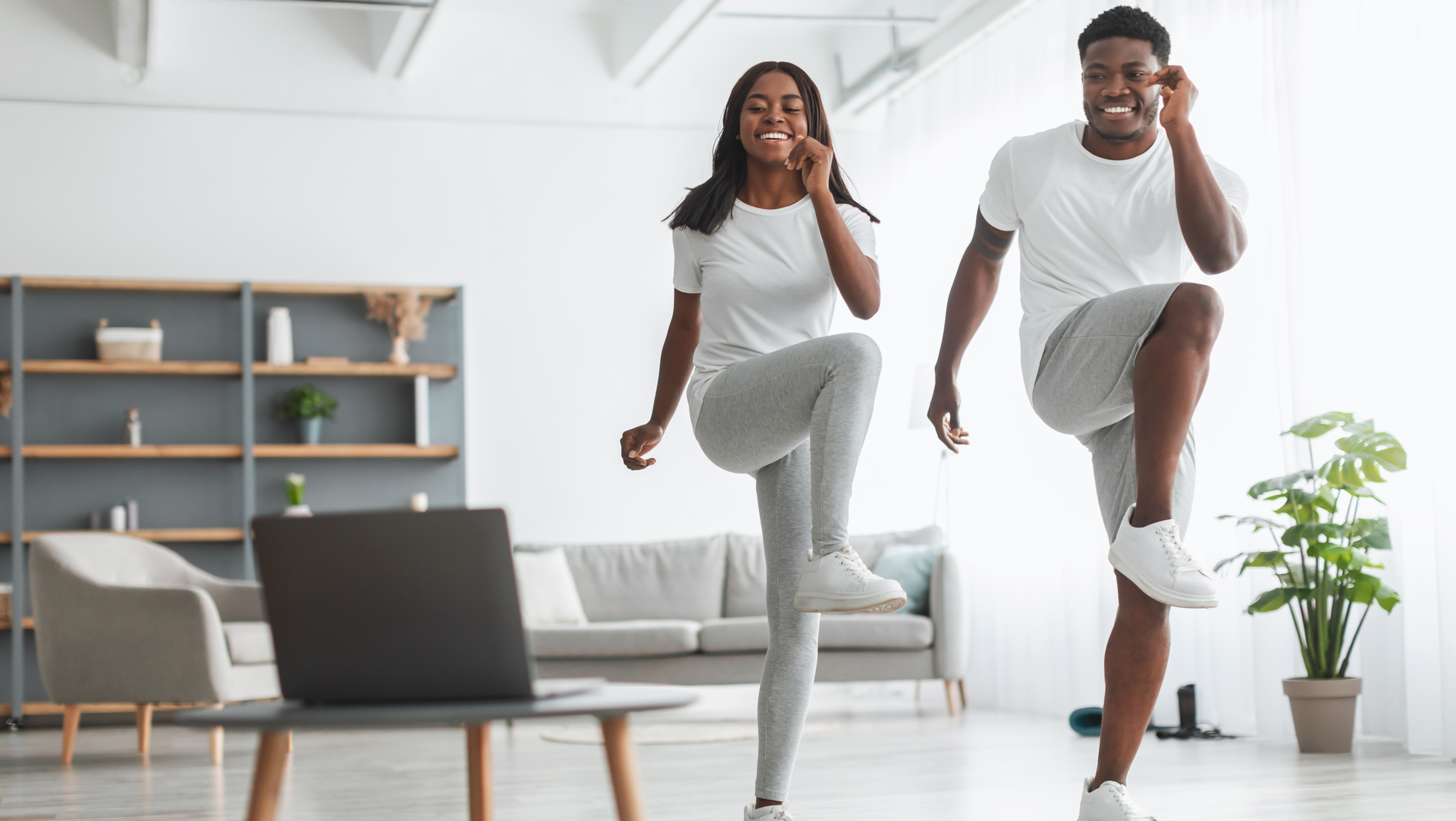 man and woman following a walking workout at home