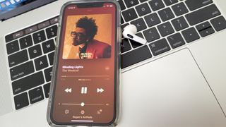 The Apple AirPods 3 playing The Weeknd's "Blinding Lights" on Apple Music