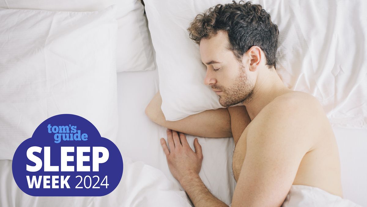 A man with curly brown hair sleeps during the deepest stage of sleep, N3