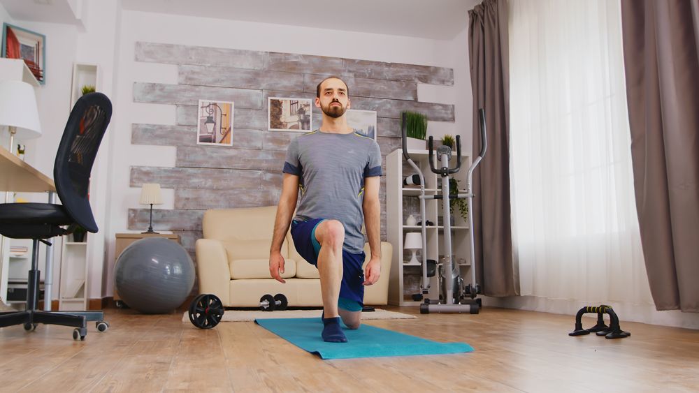 Man performs a lunge at home