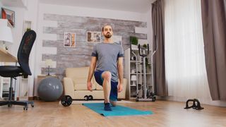 Man performs a lunge at home