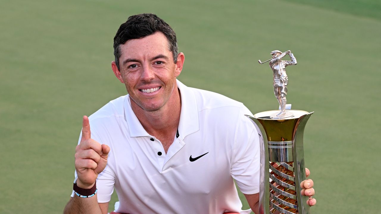 Rory McIlroy poses with the Harry Vardon trophy in 2023