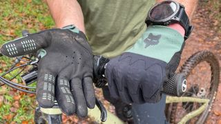 A rider wearing fox defend d3o gloves on a mountain bike