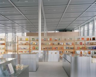 Items on shelves inside sydney modern store's orange and reflective interiors