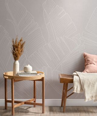 A coastal-style entryway with gray patterned wallpaper and a small wooden bench