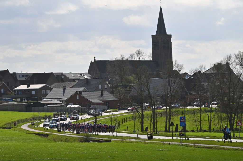 WEVELGEM BELGIUM MARCH 24 A general view of the peloton passing through a landscape during the 13rd GentWevelgem in Flanders Fields 2024 Womens Elite a 1712km one day race from Ieper to Wevelgem UCIWWT on March 24 2024 in Wevelgem Belgium Photo by Luc ClaessenGetty Images