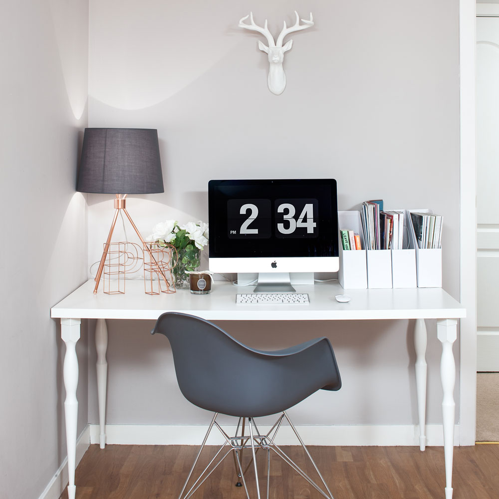 desk with an iMac and a lamp on it