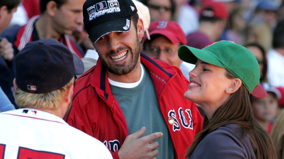 Actor Ben Affleck and wife, actress Jennifer Garner laugh with player Kevin Millar #15 of the Boston Red Sox prior to the start of the game against the New York Yankees at Fenway Park on October 1, 2005 in Boston, Massachusetts