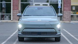 2024 Hyundai Kona Electric with projector headlights turned on.