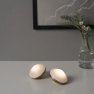 Two diamond shaped puck lights on a white coffee table