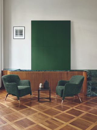 Gio Ponti's chairs covered in green velvet on wooden floor