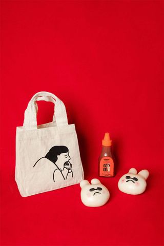 Bao Lunar New Year gift set with bunny shaped bao buns, tote bag, and bottle of hot sauce