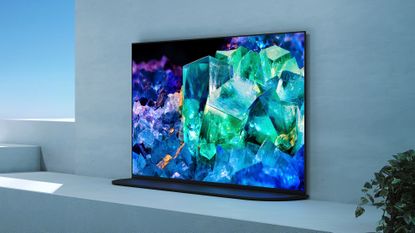 Sony A95K QD-OLED TV in room with window to the left