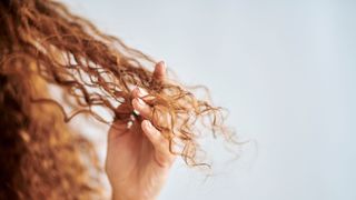 woman running fingers through curly hair