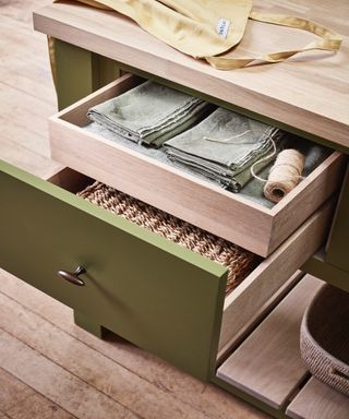 Kitchen drawers with table linens and string