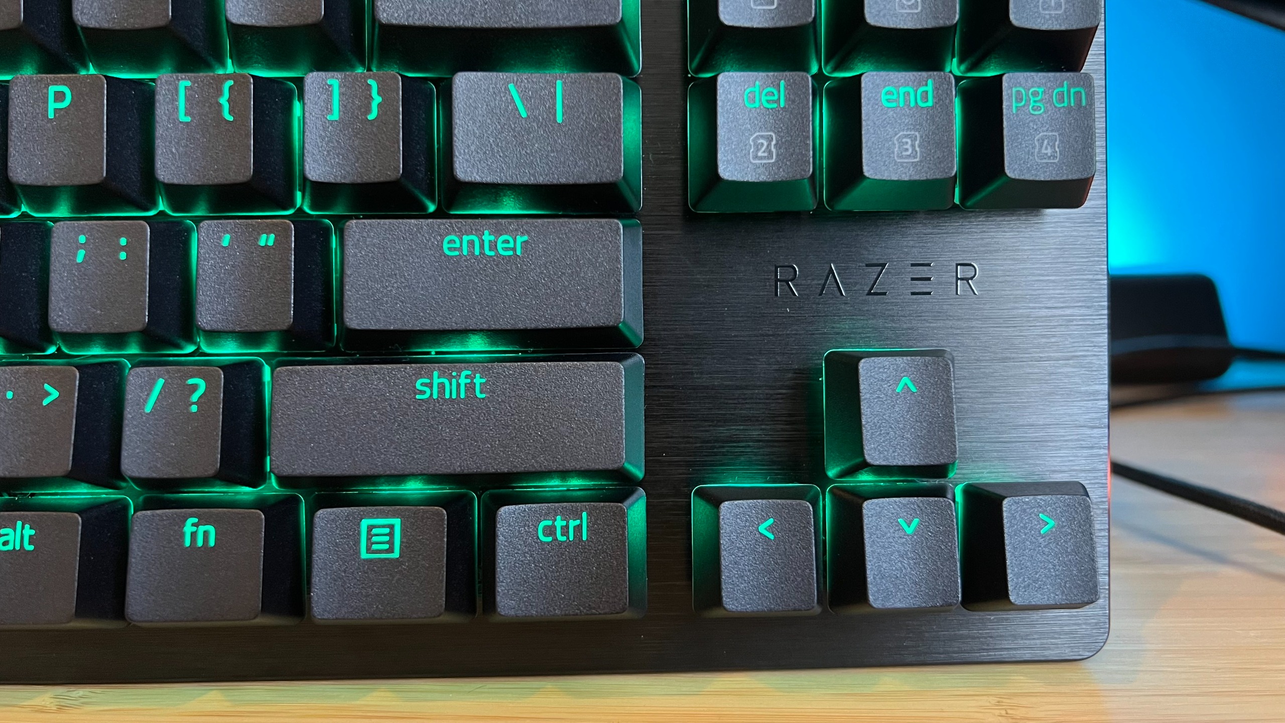 Close up on arrow buttons and brushed effect of top plate on Razer Huntsman V3 HE gaming keyboard