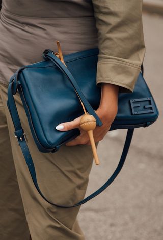 Milan fashion week spring 2025 street style photo of a woman wearing bag charm trend