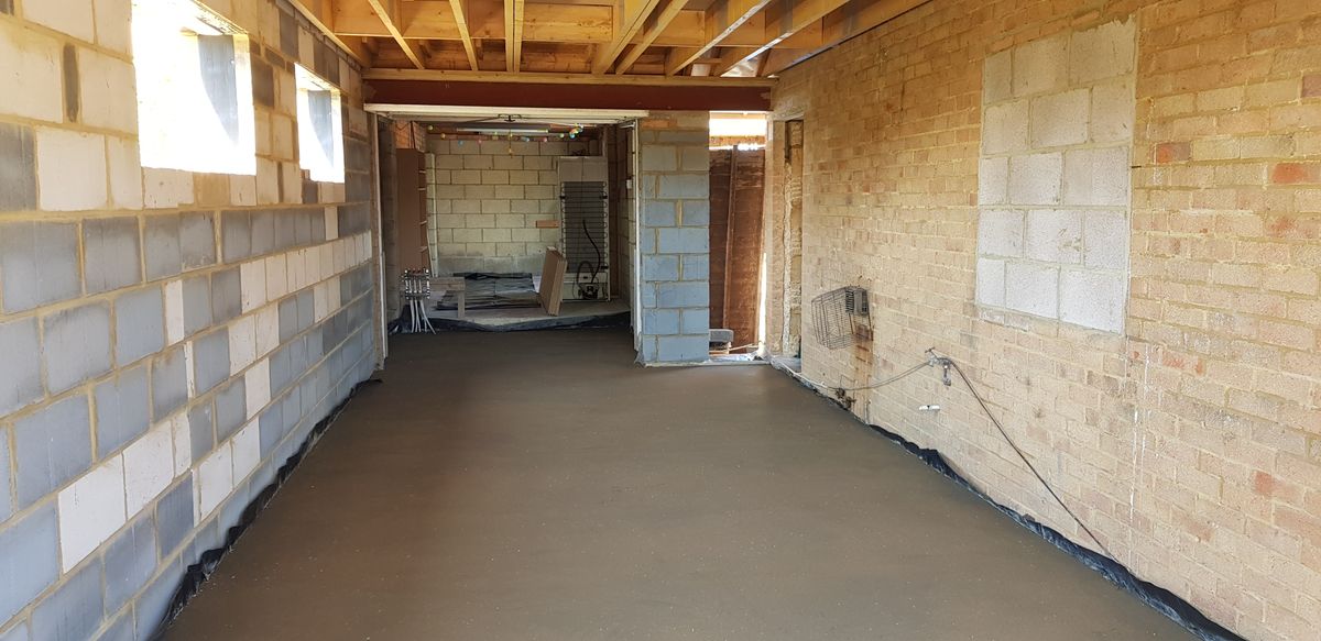A newly screeded extension to cover new underfloor heating pipes