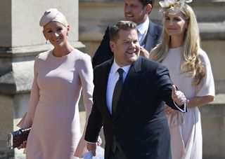 British presenter James Corden and Julia Carey arrive for the wedding ceremony of Britain's Prince Harry, Duke of Sussex and US actress Meghan Markle at St George's Chapel, Windsor Castle, in Windsor, on May 19, 2018. (Photo by TOBY MELVILLE / POOL / AFP) (Photo credit should read TOBY MELVILLE/AFP via Getty Images)