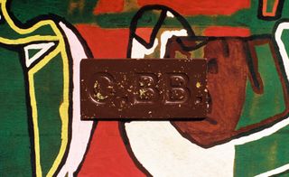 Casa Bosques Chocolates The Maker Series chocolate bar on background of art created by Joe Light