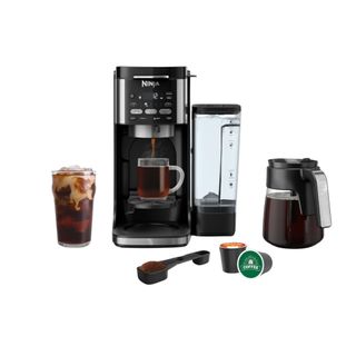 Ninja DualBrew Pro in black with accessories next to the machine as well as a cup of coffee