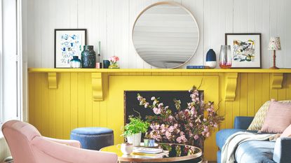 A living room with a two-toned wall in yellow and white with a wood panelled finish