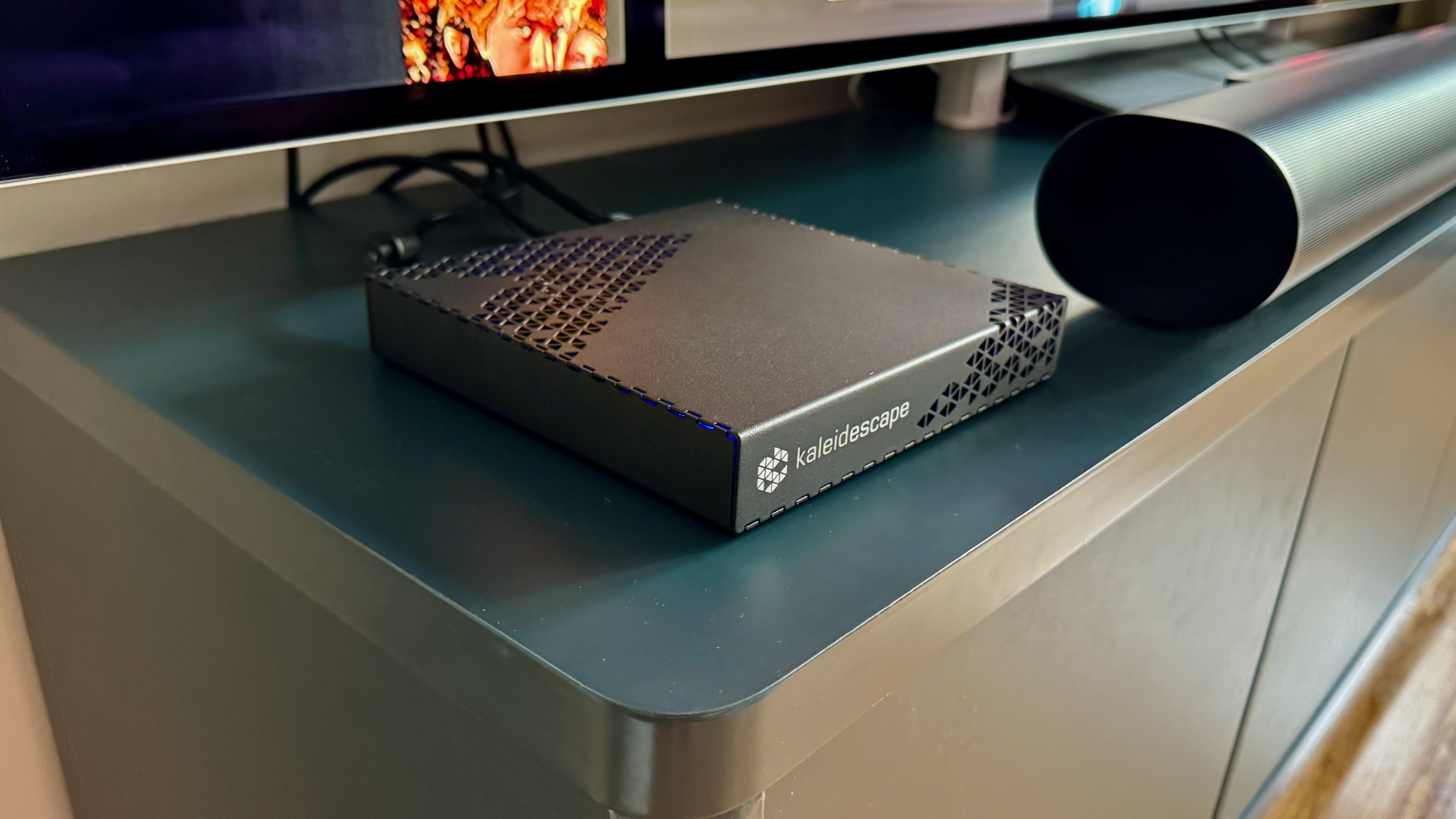 Kaleidescape Strato E Movie Player on a blue TV unit.