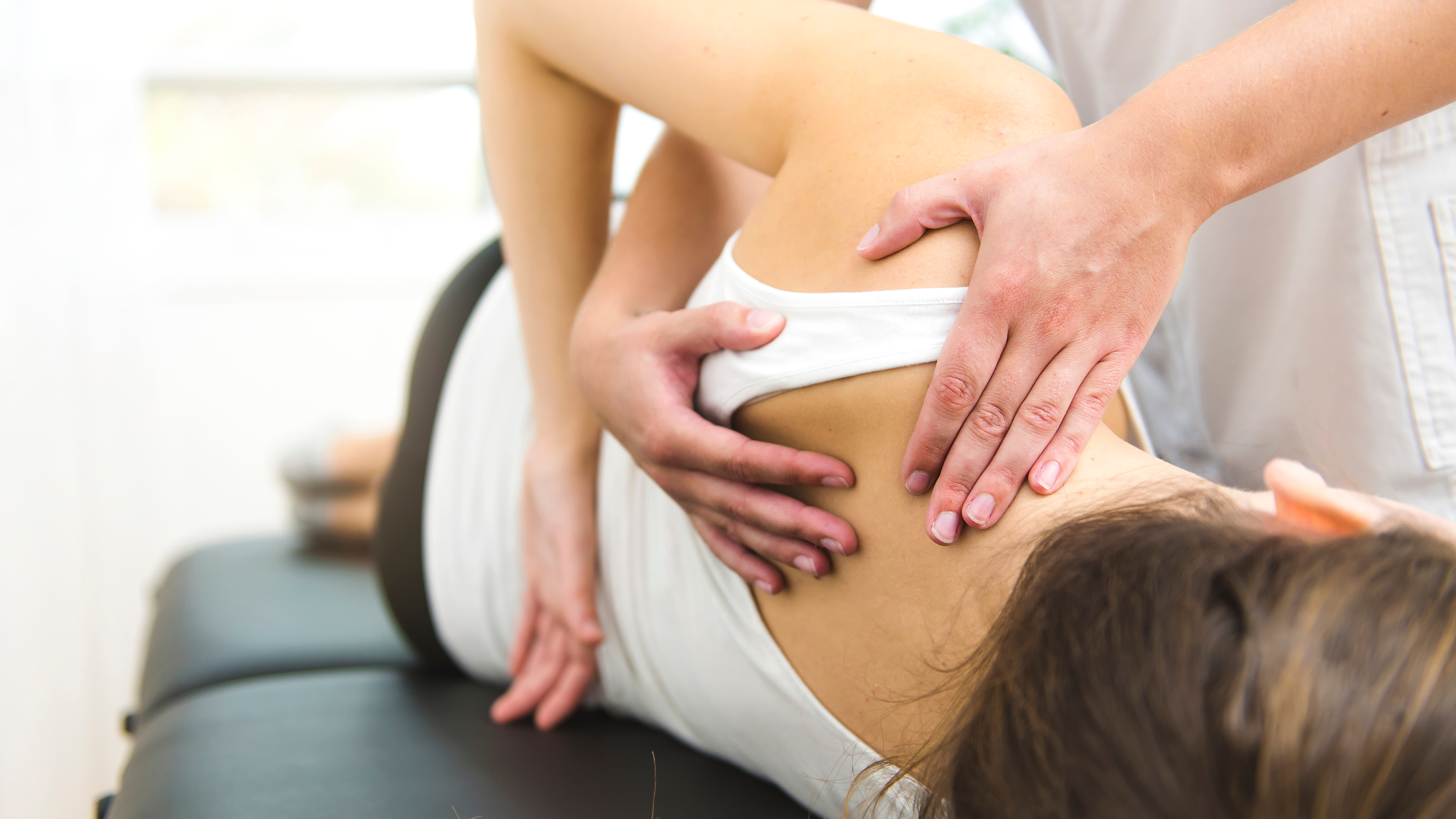 a woman getting help stretching her upper body