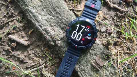 Polar Grit X2 Pro watch on the ground with clock face and step count