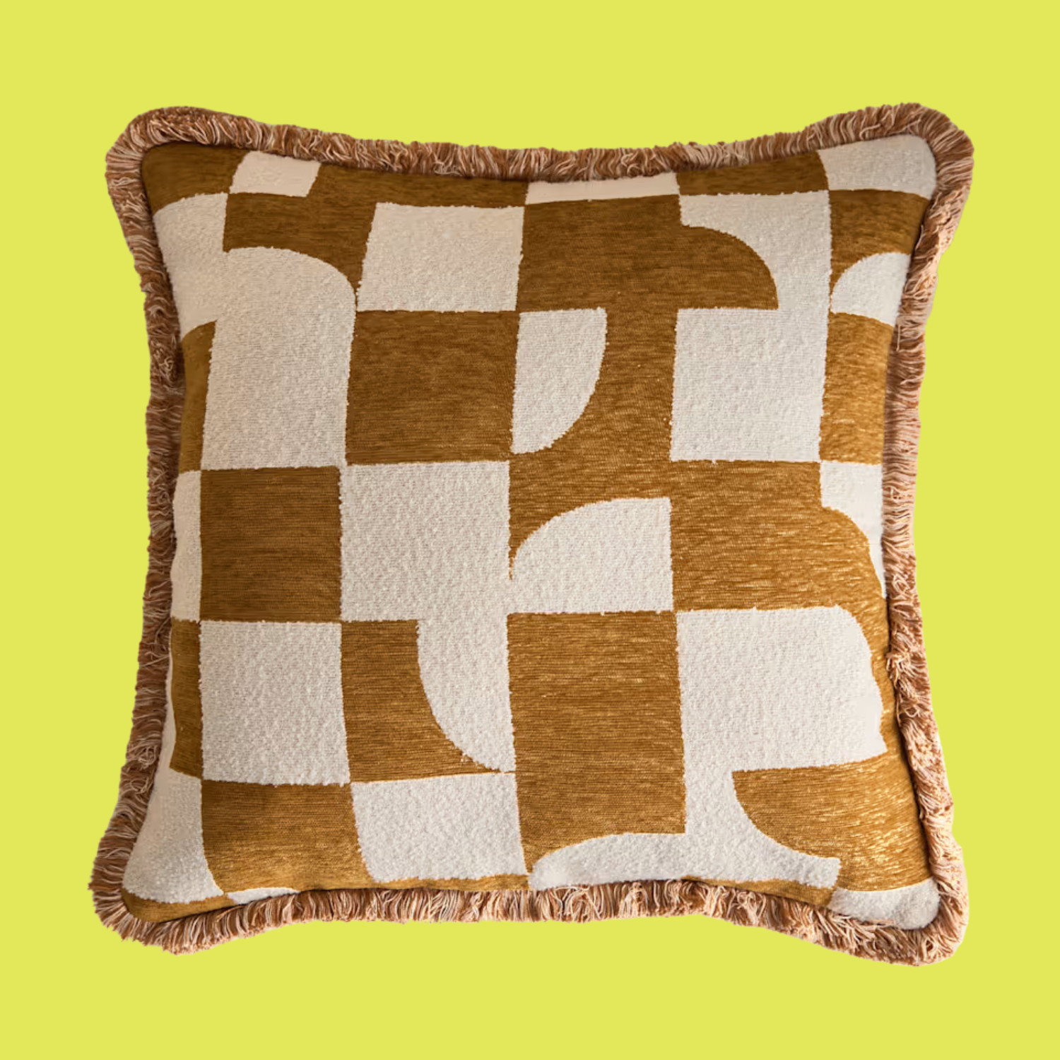 A cushion with a short fringe hem and an ochre geometric pattern