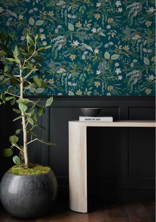 dark botanical wallpaper above dark blue paneling