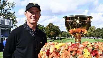 International team Mike Weir poses with the Presidents Cup in Montreal